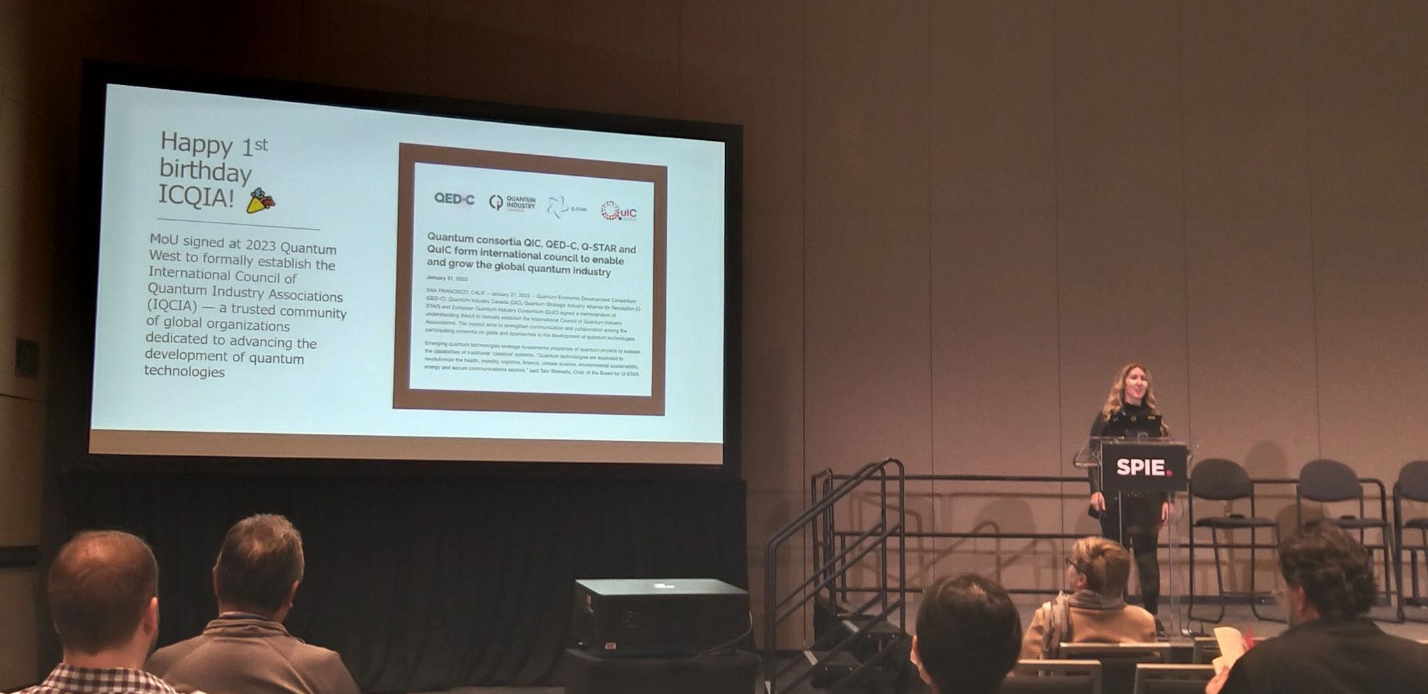 QIC CEO Lisa Lambert presenting on stage at SPIE's Photonics West