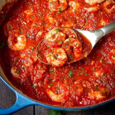 Shrimp and tomato sauce in a skillet.