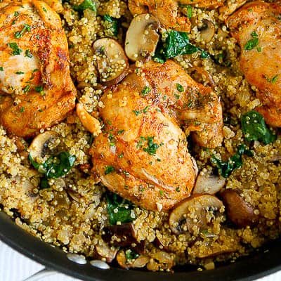 Chicken, quinoa and mushrooms in a skillet.
