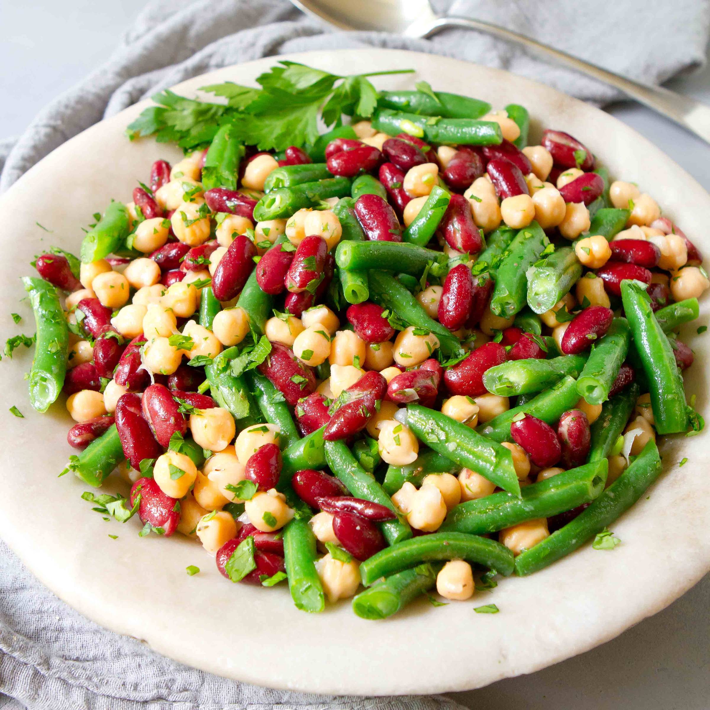 Green beans, kidney beans and chickpeas in a stone bowl.