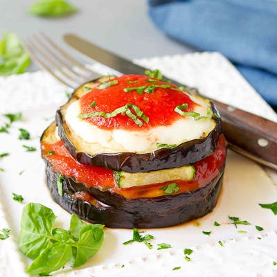 Grilled eggplant layered with tomato sauce, cheese and zucchini.