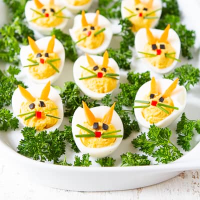 Deviled eggs decorated to look like bunnies.