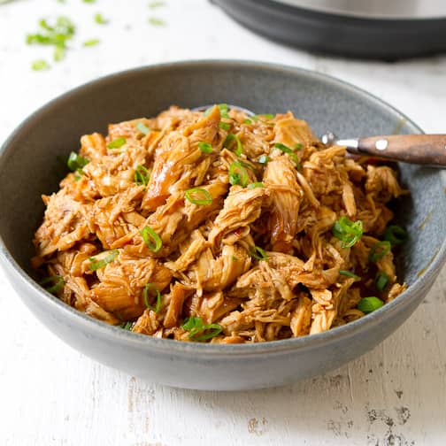 Shredded hoisin chicken in a gray bowl.