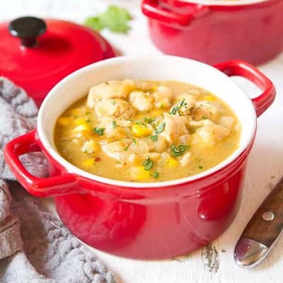 White chicken chili in a red bowl.