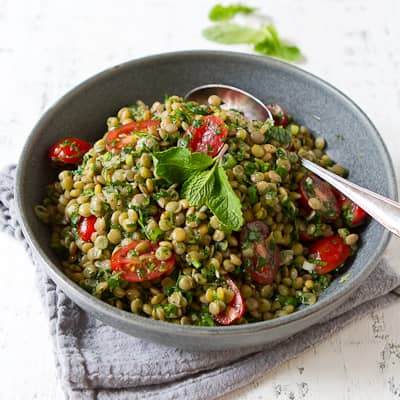 Lentil tabbouleh salad in a gray bowl.