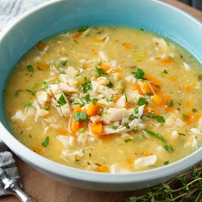 Turkey barley soup in a blue bowl.