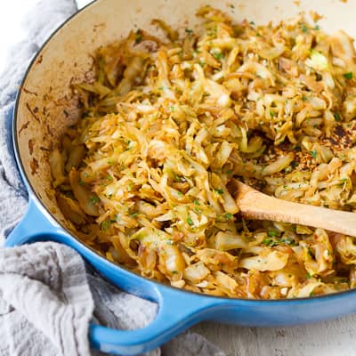 Caramelized cabbage and onions in a large skillet.