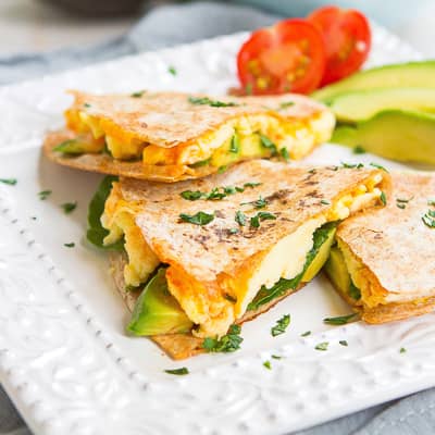 A quesadilla filled with eggs, cheese and avocado.