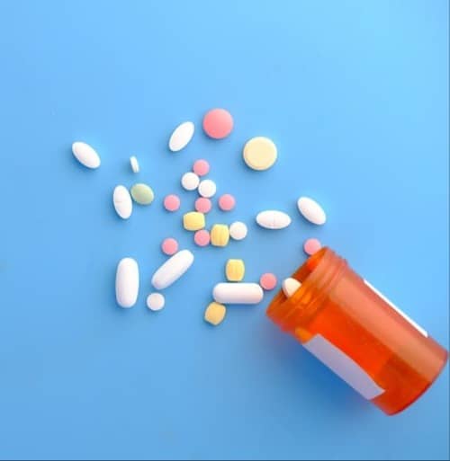 orange and white medication pill