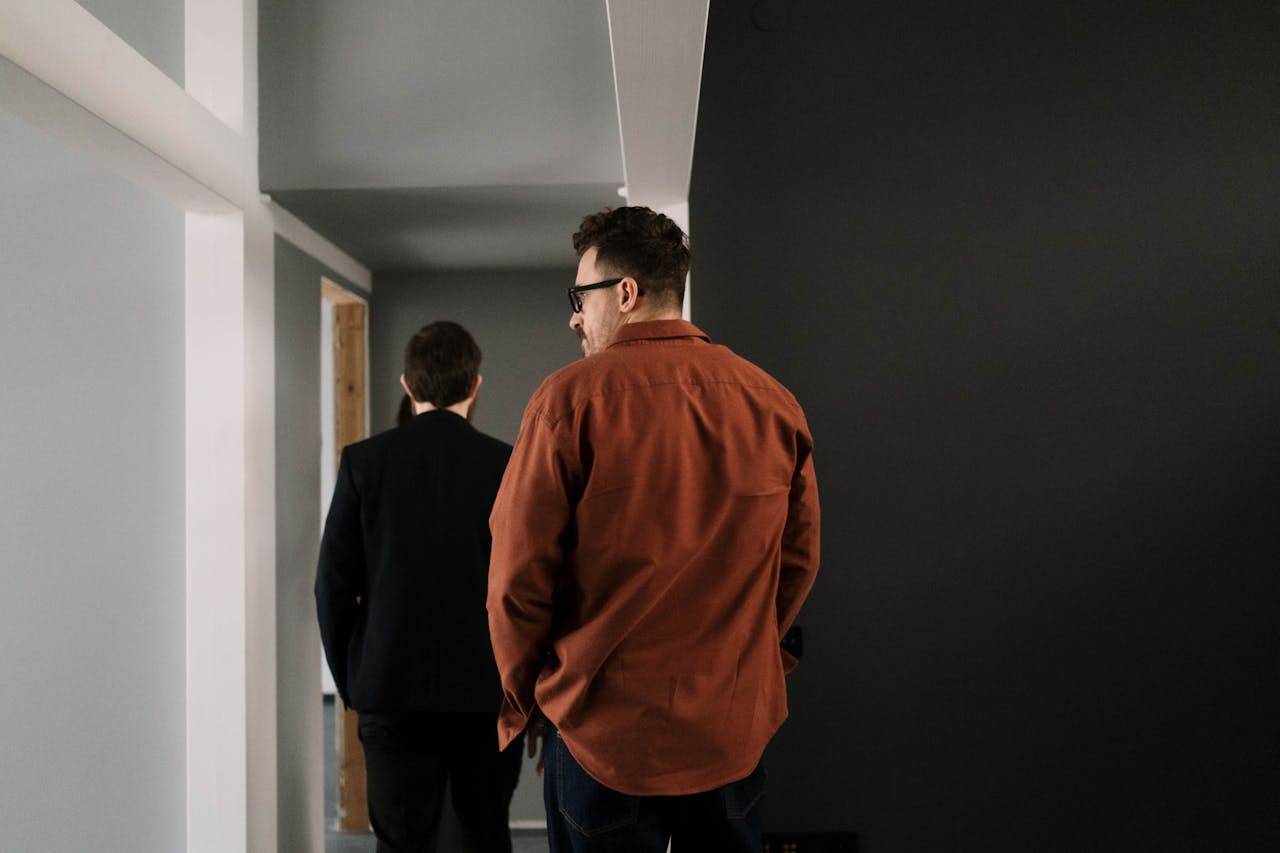 two men walking down in an office lobby