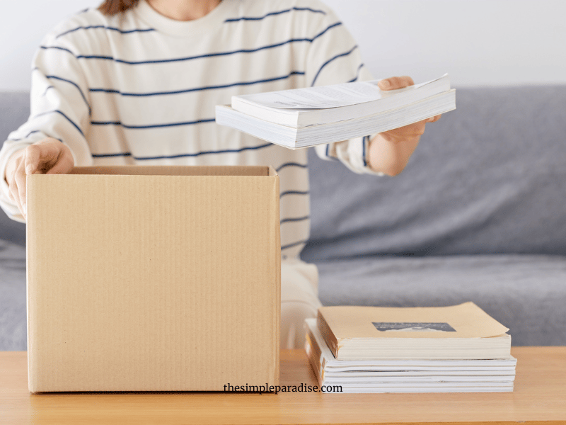 Woman decluttering with box