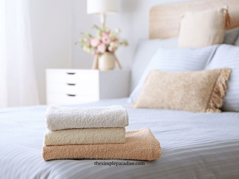 towels folded on the edge of the bed