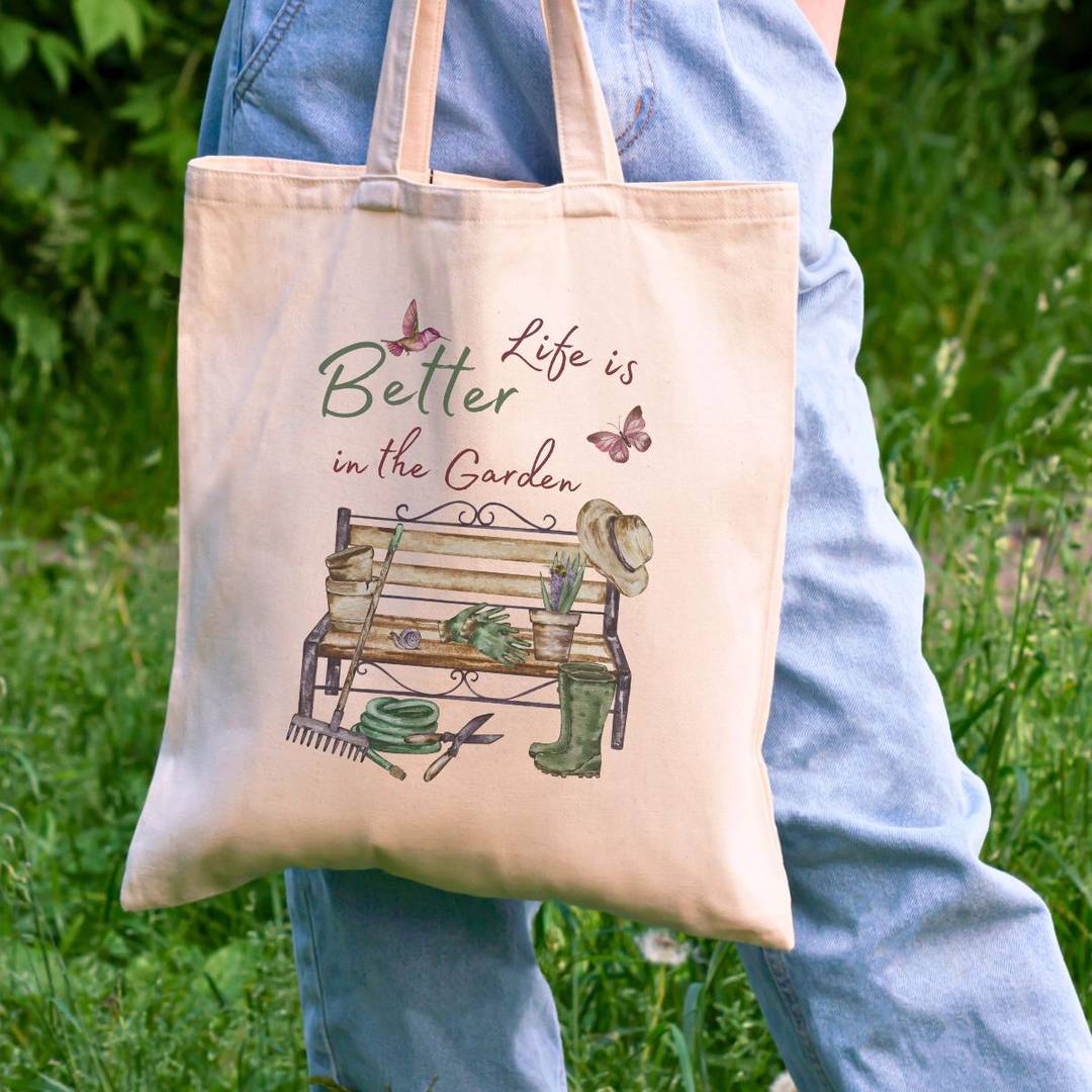 a person carrying a bag that says life is bette in the garden.
