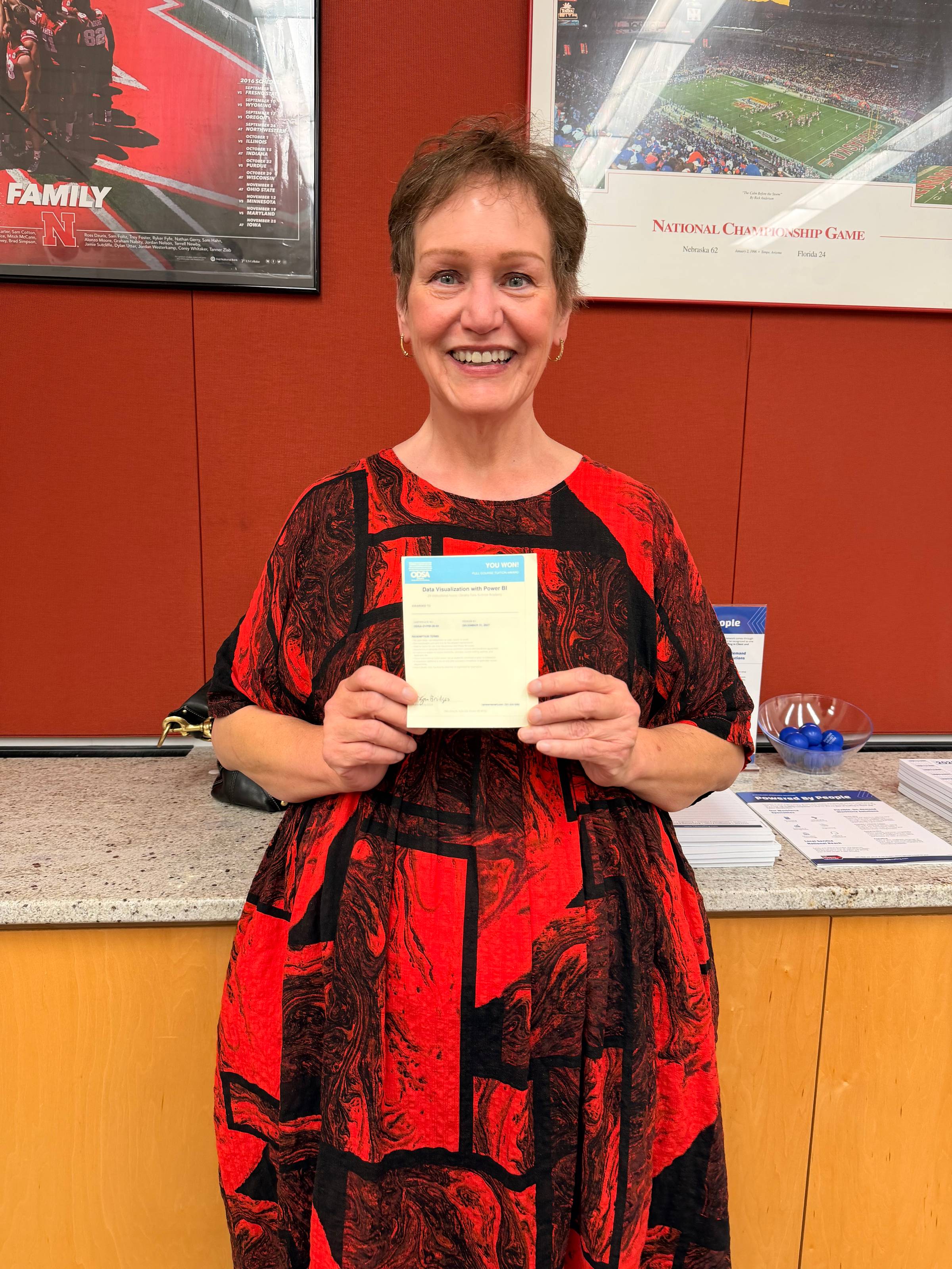 The second winner holding their gift certificate! 