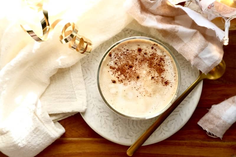A close-up of a creamy beverage dusted with cinnamon.
