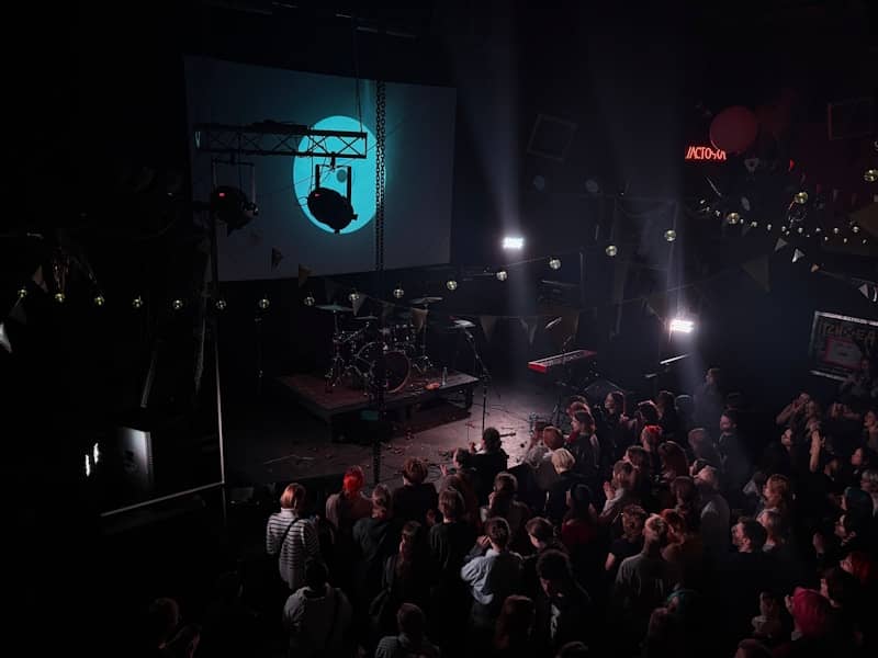 A concert venue with an audience watching.