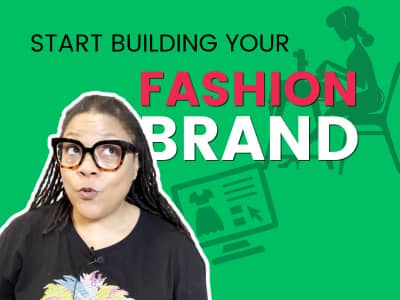 Mikelle Drew-Pellum, a Black woman with locs and bold glasses, stands against a bright green background with a wide-eyed, expressive look. Bold black and pink text reads "Start Building Your Fashion Brand." A silhouette illustration of a designer working 