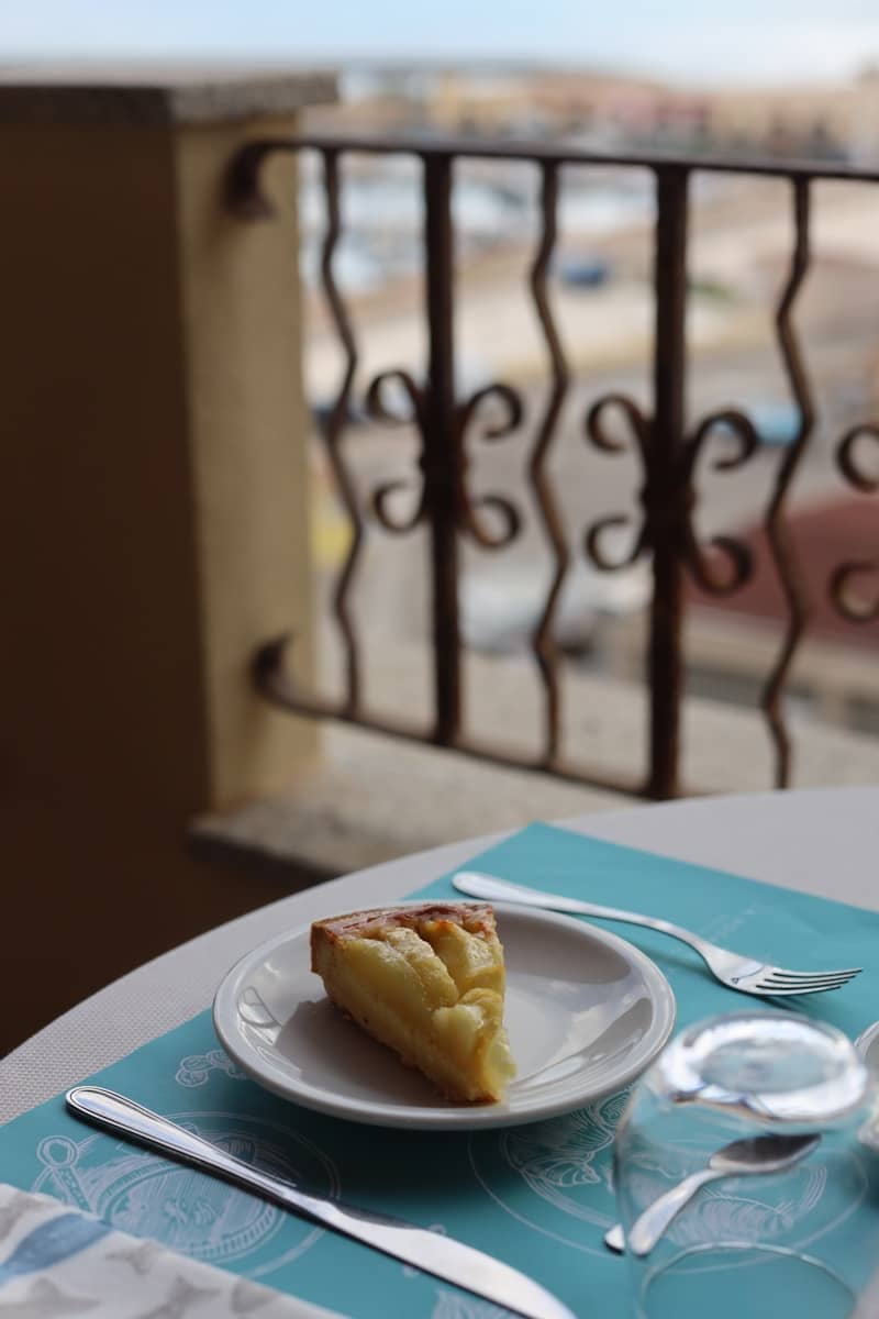 Delicious cake slice on a table overlooking a balcony.
