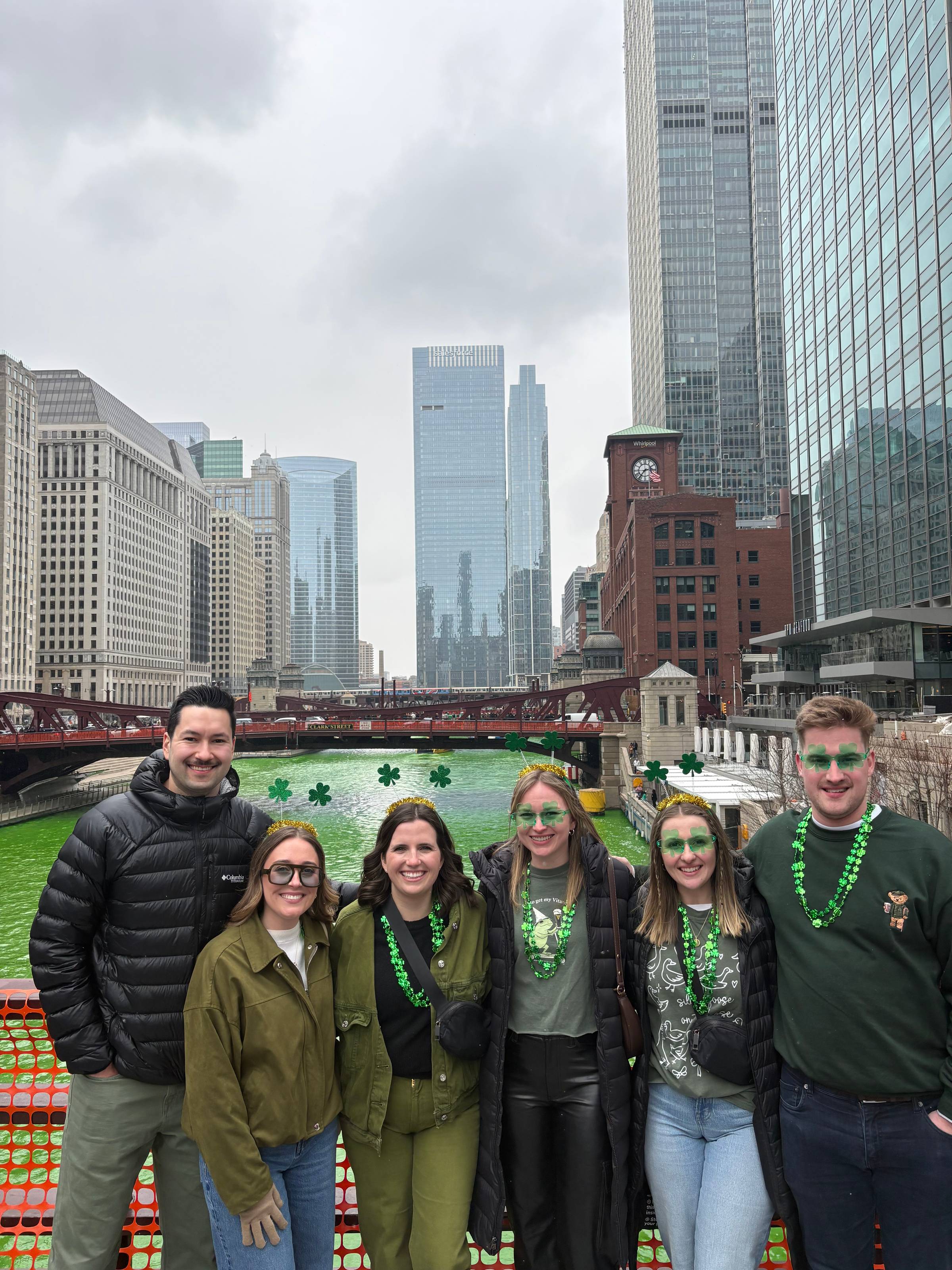 Group of friend in front of the green river in Chicago