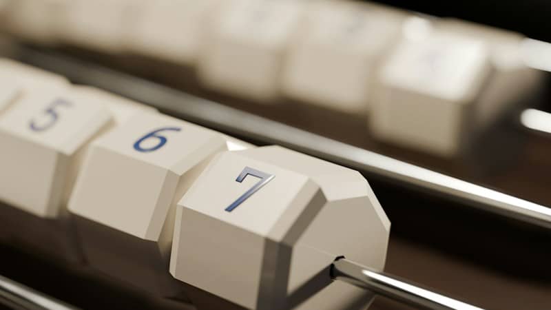 Close-up of white numbered blocks on metal rods in a row