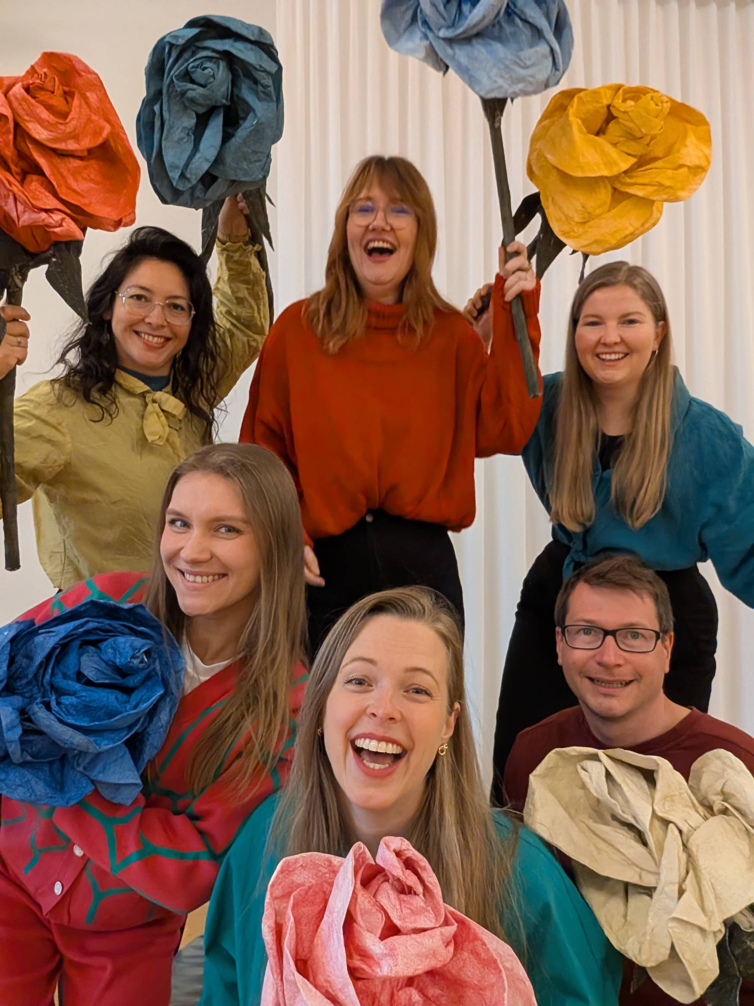 6 people with big colourful flowers