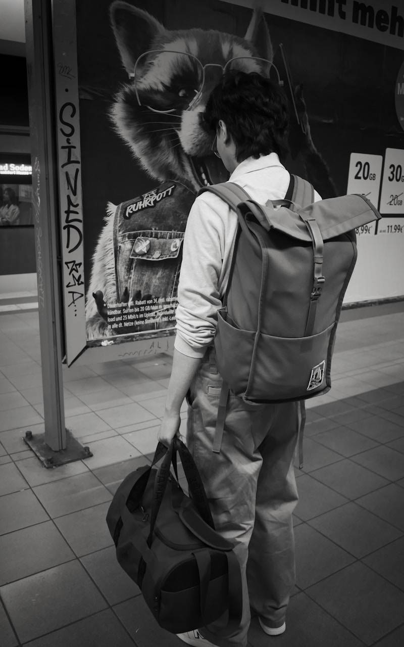 A person stands near a raccoon advertisement.