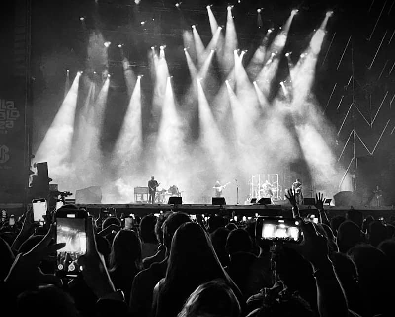 A crowd watches a concert on stage.