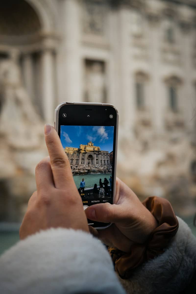 a person taking a picture of a building with a cell phone