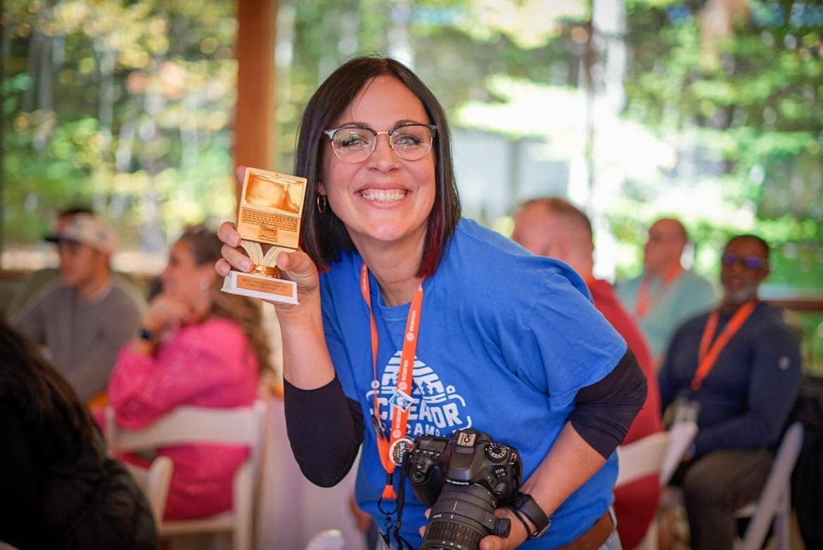 photo of Jill holding a golden computer trophy.