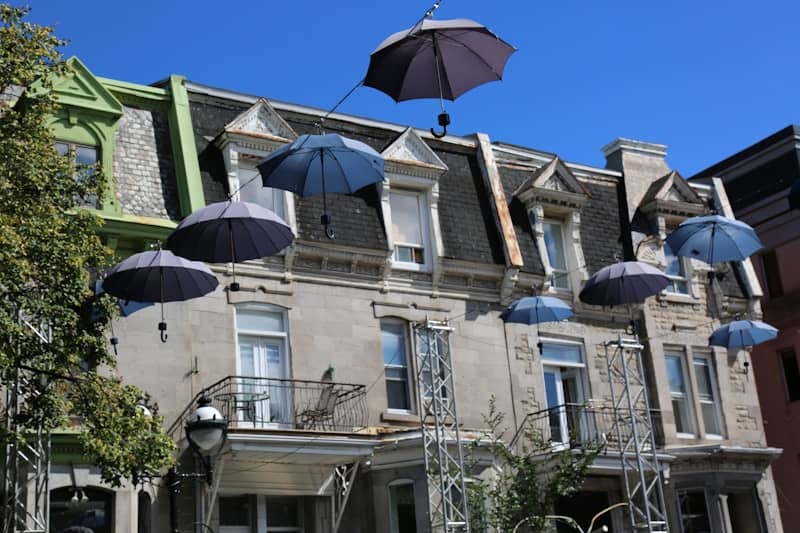 several umbrellas are from a building