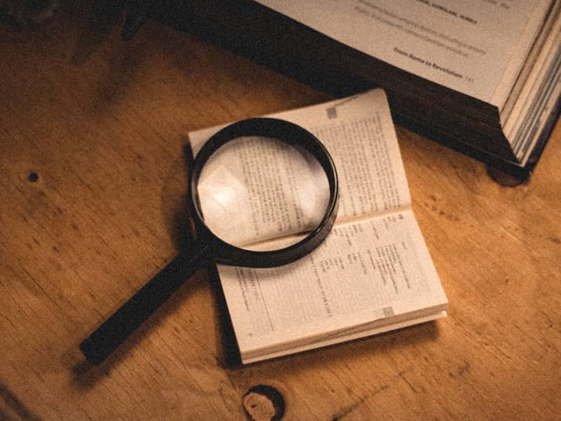 a magnifying glass sitting on top of an open book