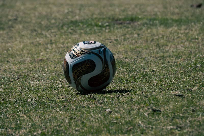 A patterned soccer ball on a patch of green grass
