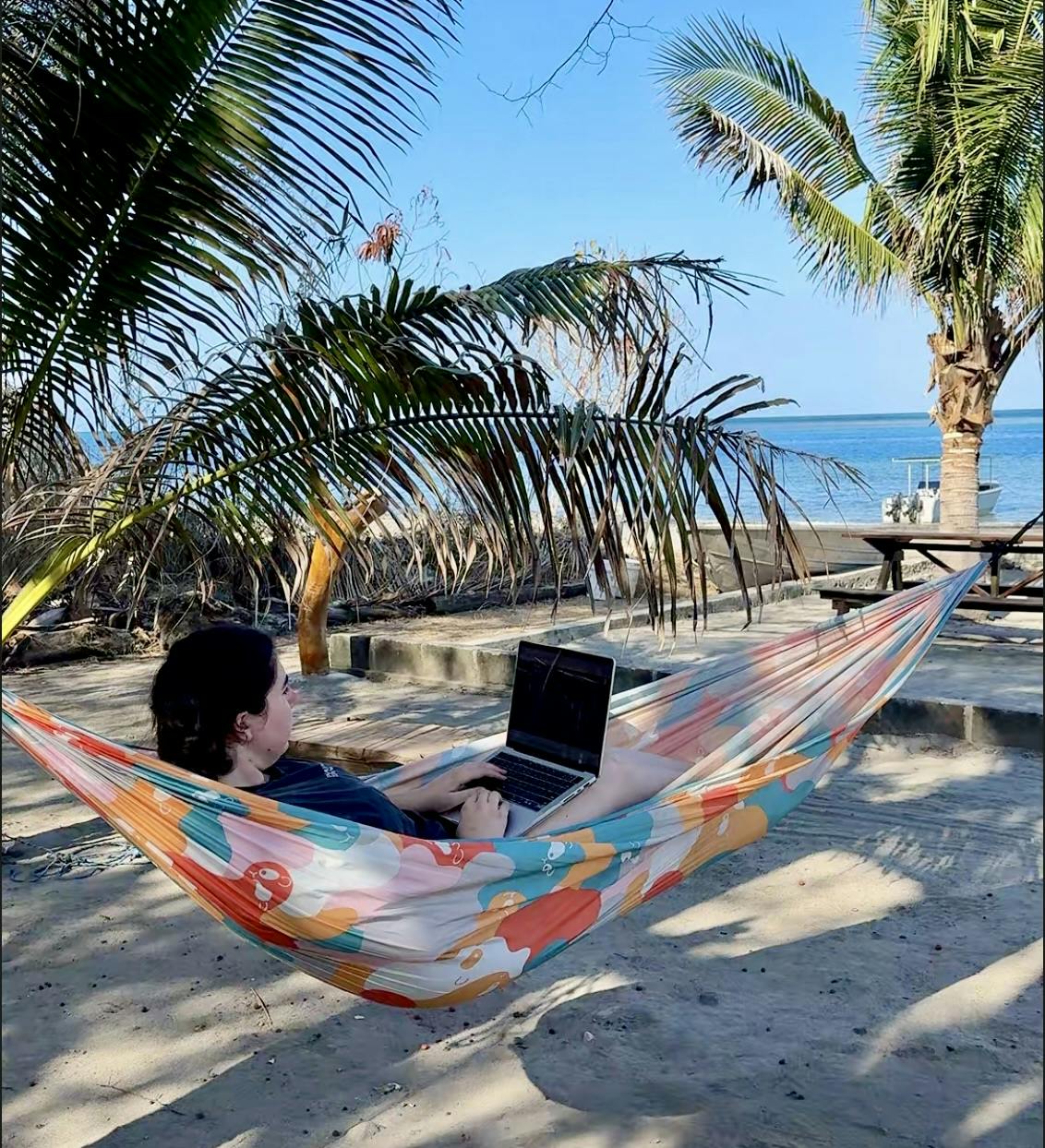 Elaina working on her laptop in a hammock in front of our bungalow at Atauro Dive Resort in Timor-Leste.