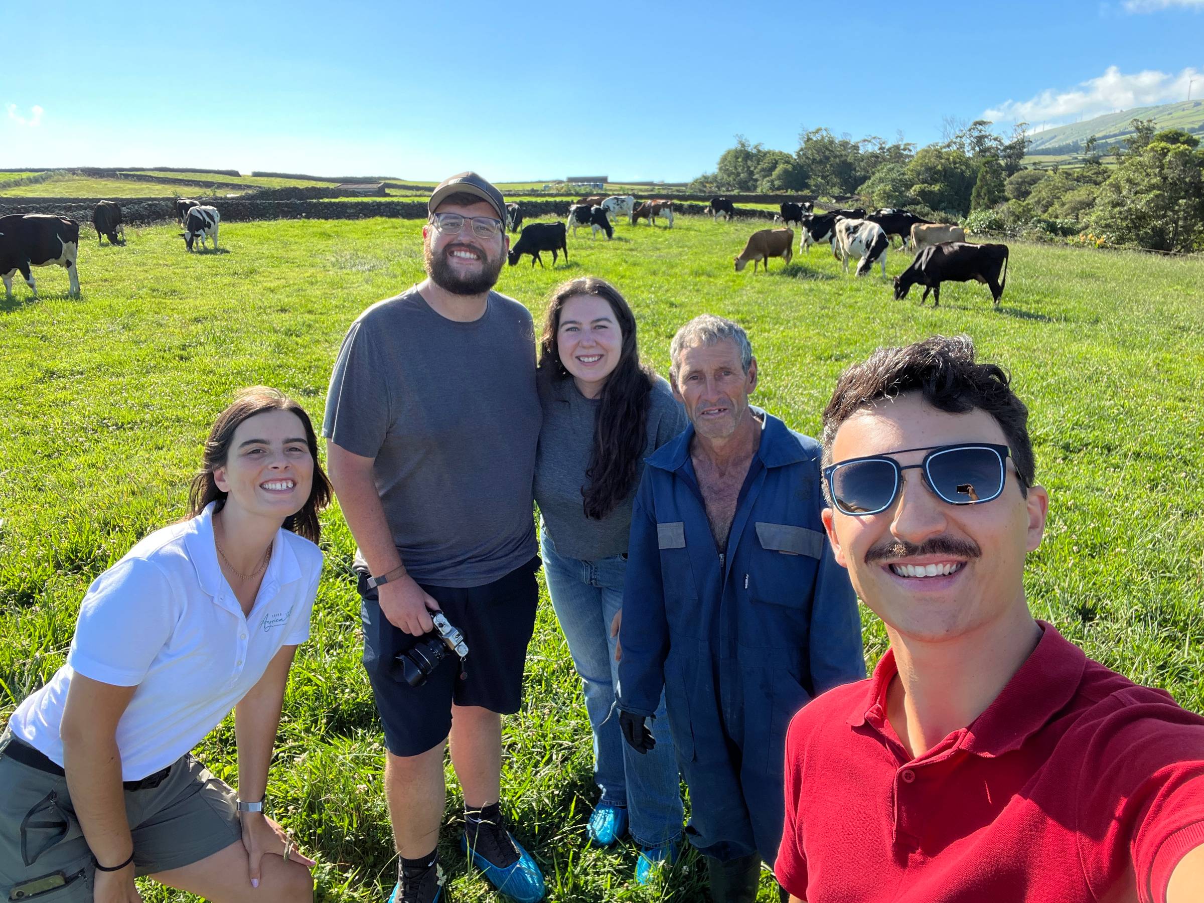 Carolina (Azorica tour guide), Zac, Elaina, Jose (dairyman), and Carlos (Azorica team member) on the dairy