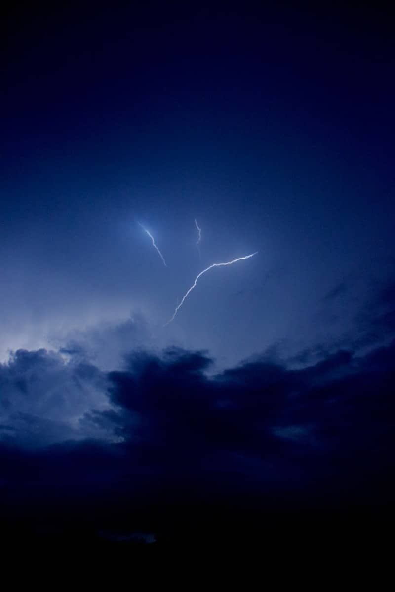 A lightning bolt is seen in the night sky