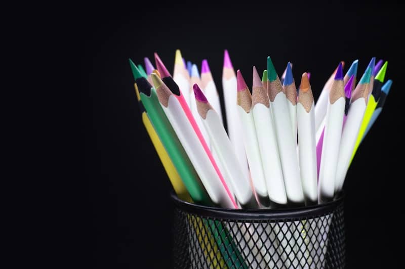 A pen holder with assorted colored pencils.