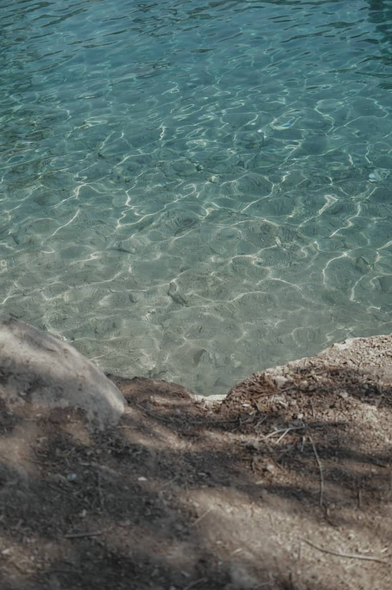 Clear turquoise water with sunlight reflections on the surface