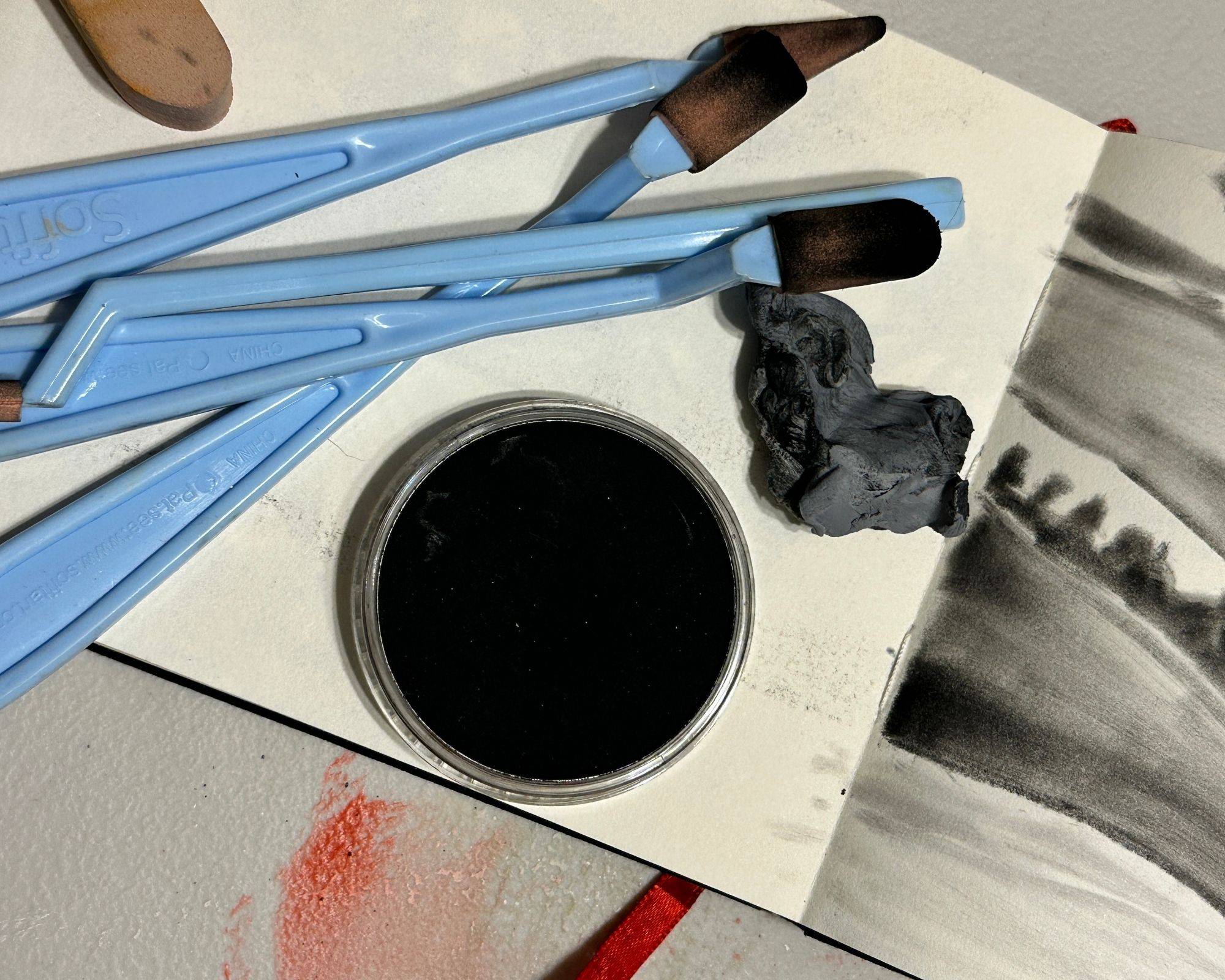 pan pastel and tools on sketchbook