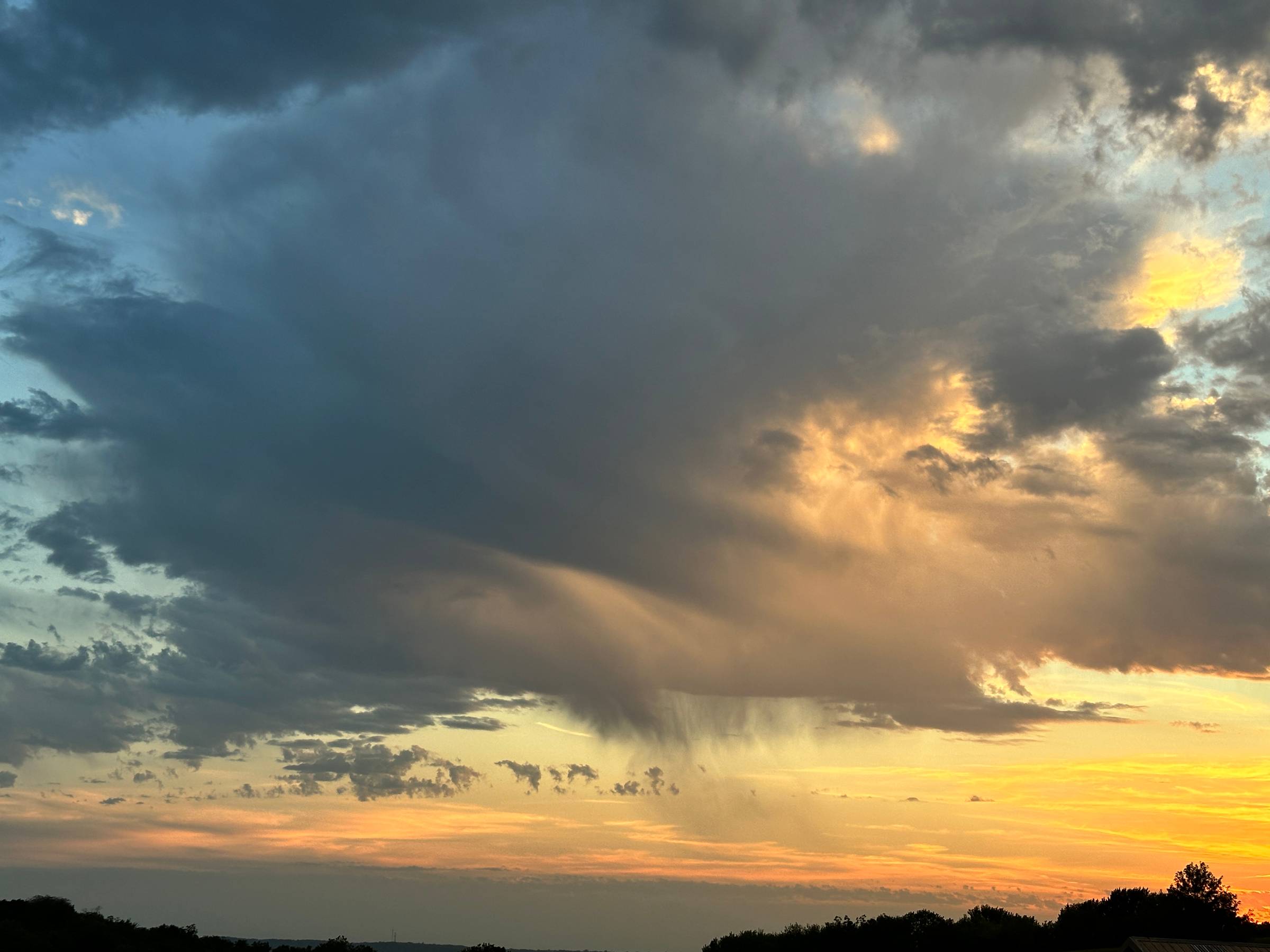 a beautiful storm cloud at sunset from my backyard