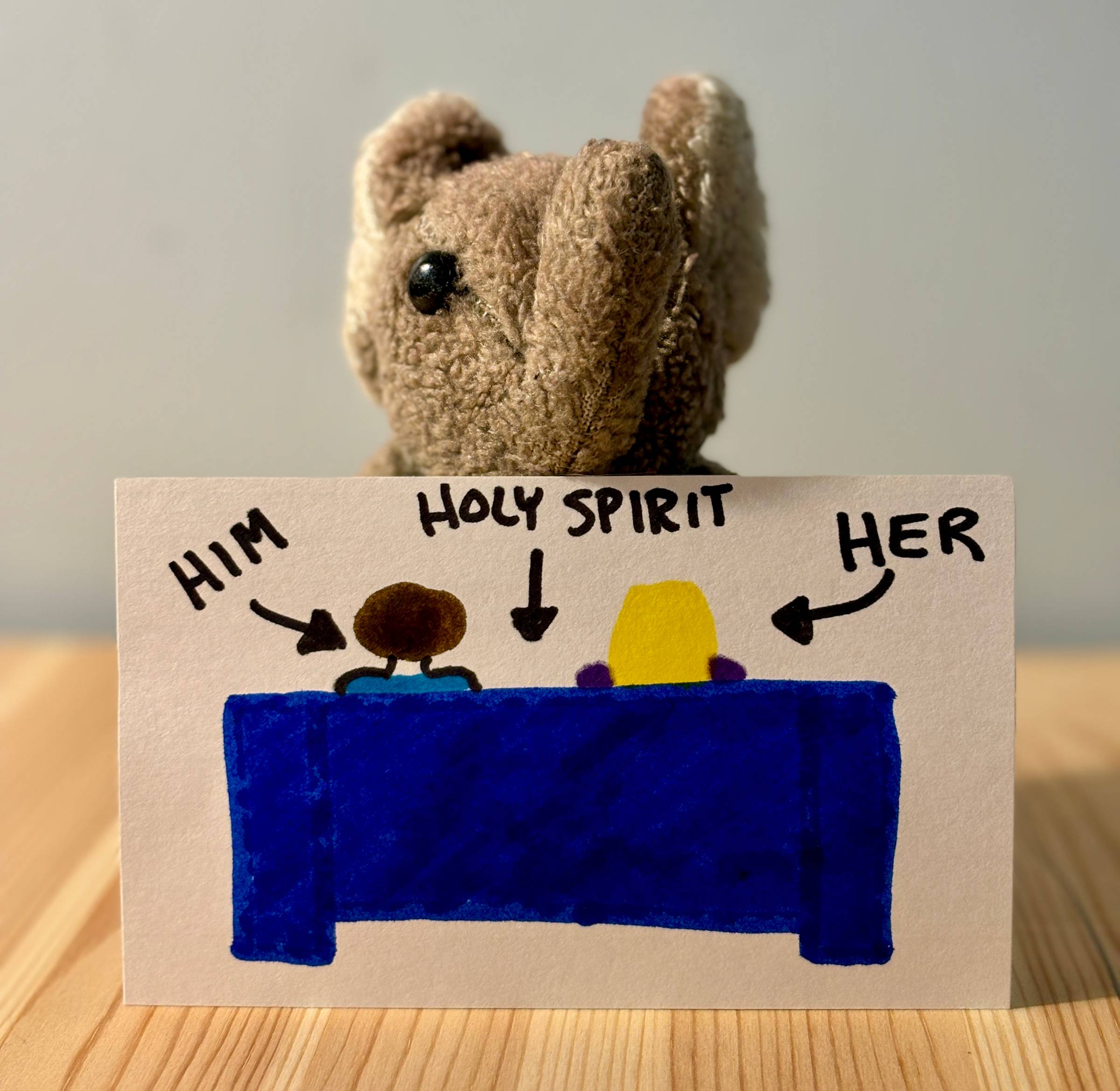 Paul holding a picture of a "him" and a "her" on a couch, separated by the Holy Spiritt