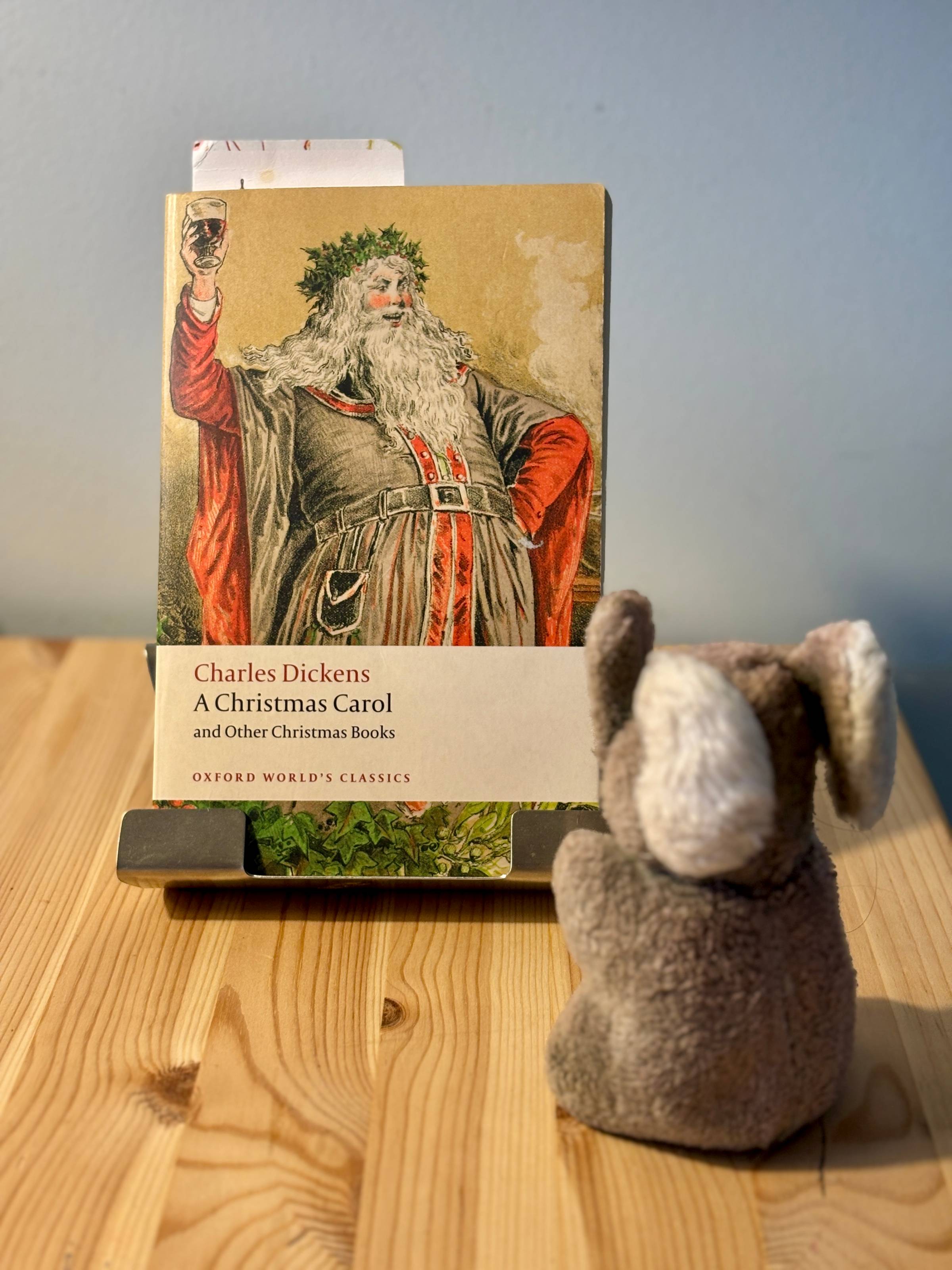 Paul sitting next to a copy of A Christmas Carol and Other Christmas Books by Charles Dickens