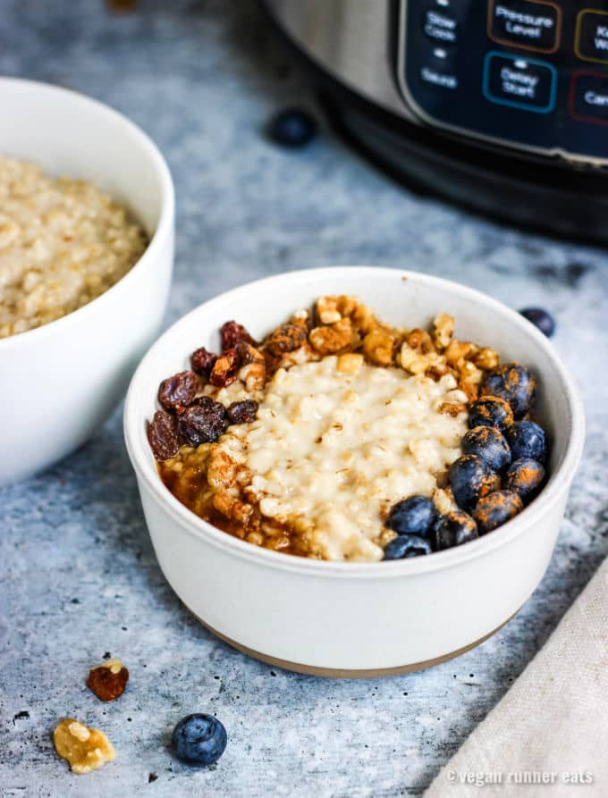 A bowl of steel cut oatmeal topped with berries and nuts