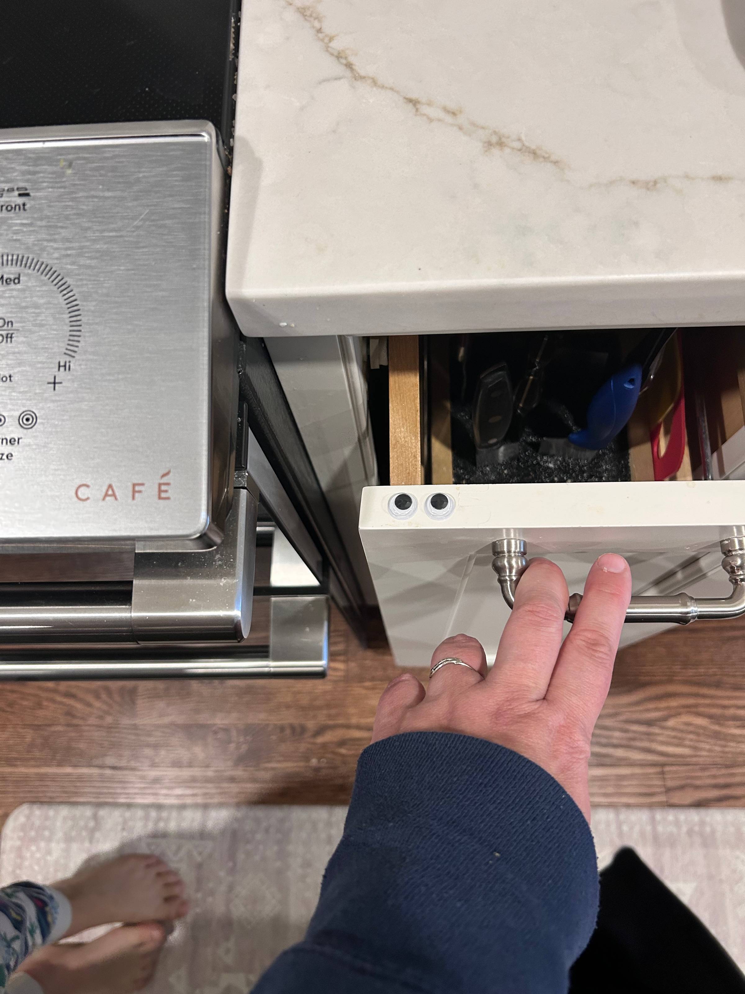 googly eyes on a drawer being pulled open