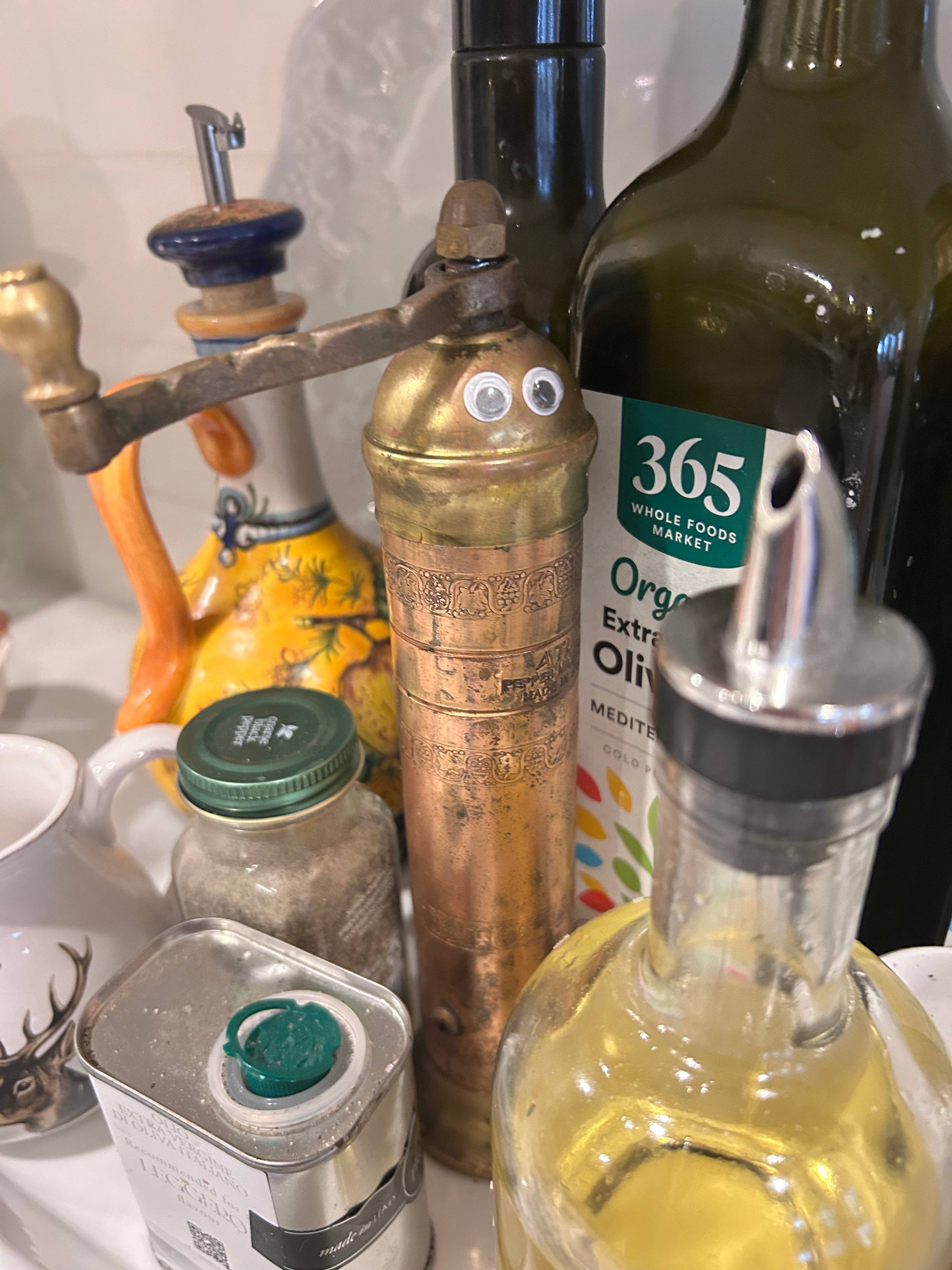 googly eyes on a copper pepper mill