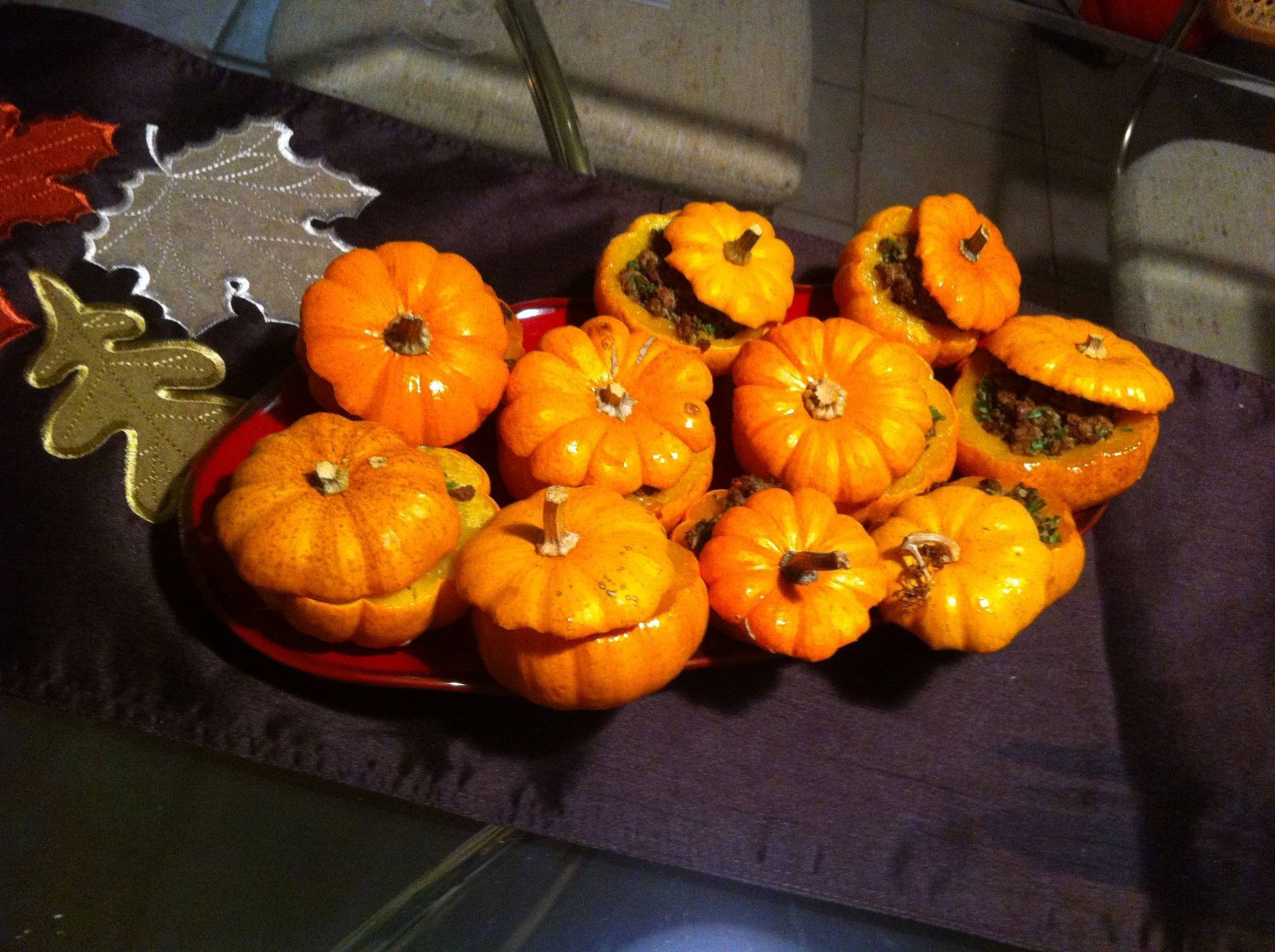 Stuffed mini pumpkins on a fall table at a supper club gathering.