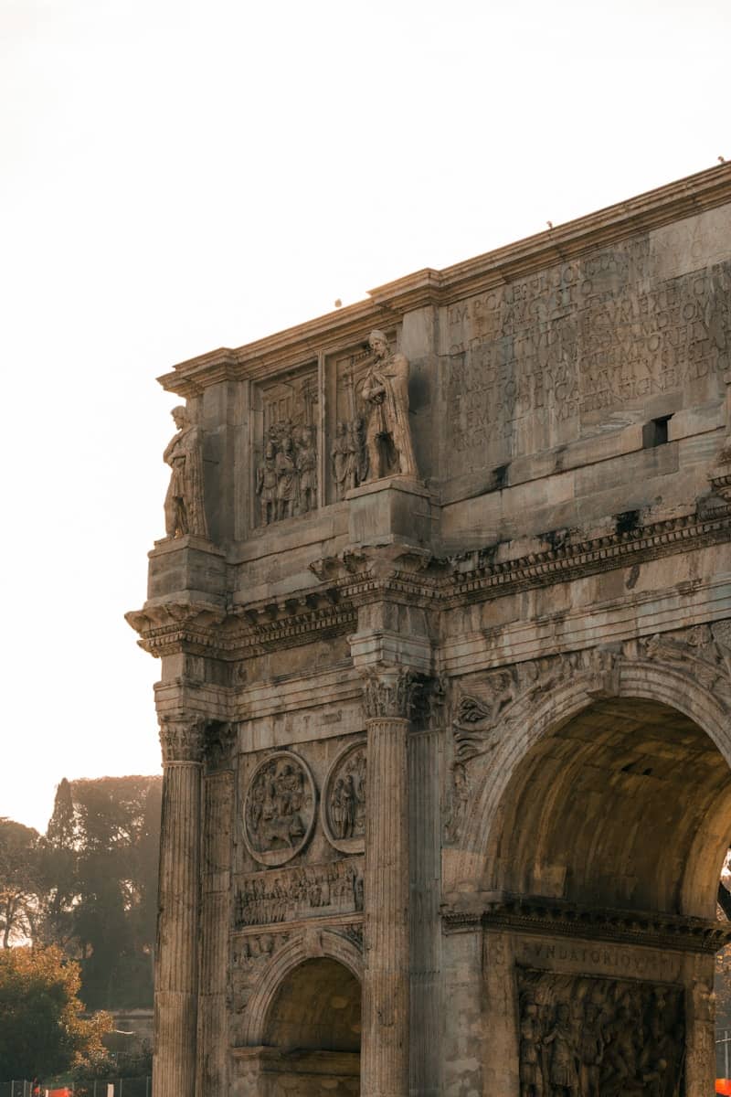 Ancient roman triumphal arch against a bright sky.