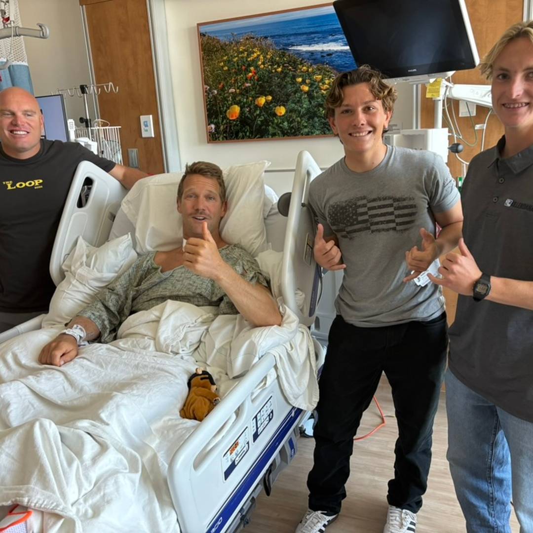 Scott Muir in his hospital bed with Judah at his side