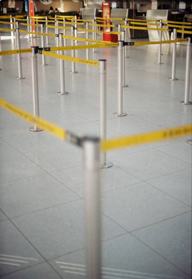 Retractable yellow belt barriers in an empty terminal at Cologne Bonn Airport