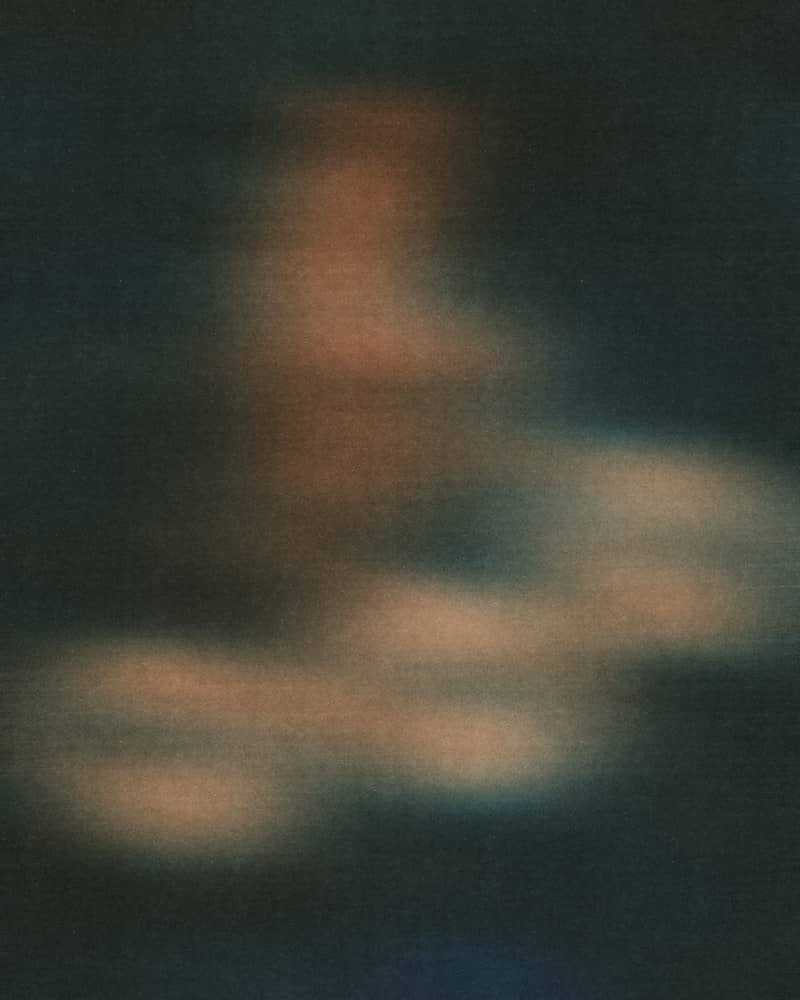 Abstract blurred shapes in muted orange and dark blue tones