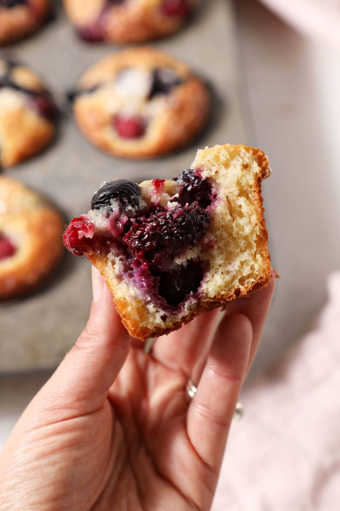 hand holding a blueberry muffin.